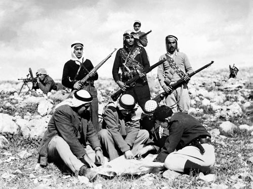 chalil rissas (khalil rassas), abd al-qadir al-husayni, studying maps with his aides, among them kassim al-rimawi (catalogued in the archive: ''arab gangs in jerusalem mountains''), 1948, haganah history archive. rissass photographs from the haganah archive were looted from the photographers studio by an israeli officer. 