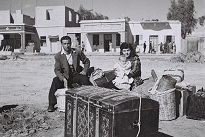 zoltan kluger, an immigrants� family sitting on their luggage in the main square in yehud, 01/10/1948. the government press office, israel.